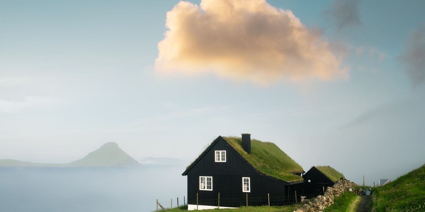 Foggy morning view of a house with typical grass roof