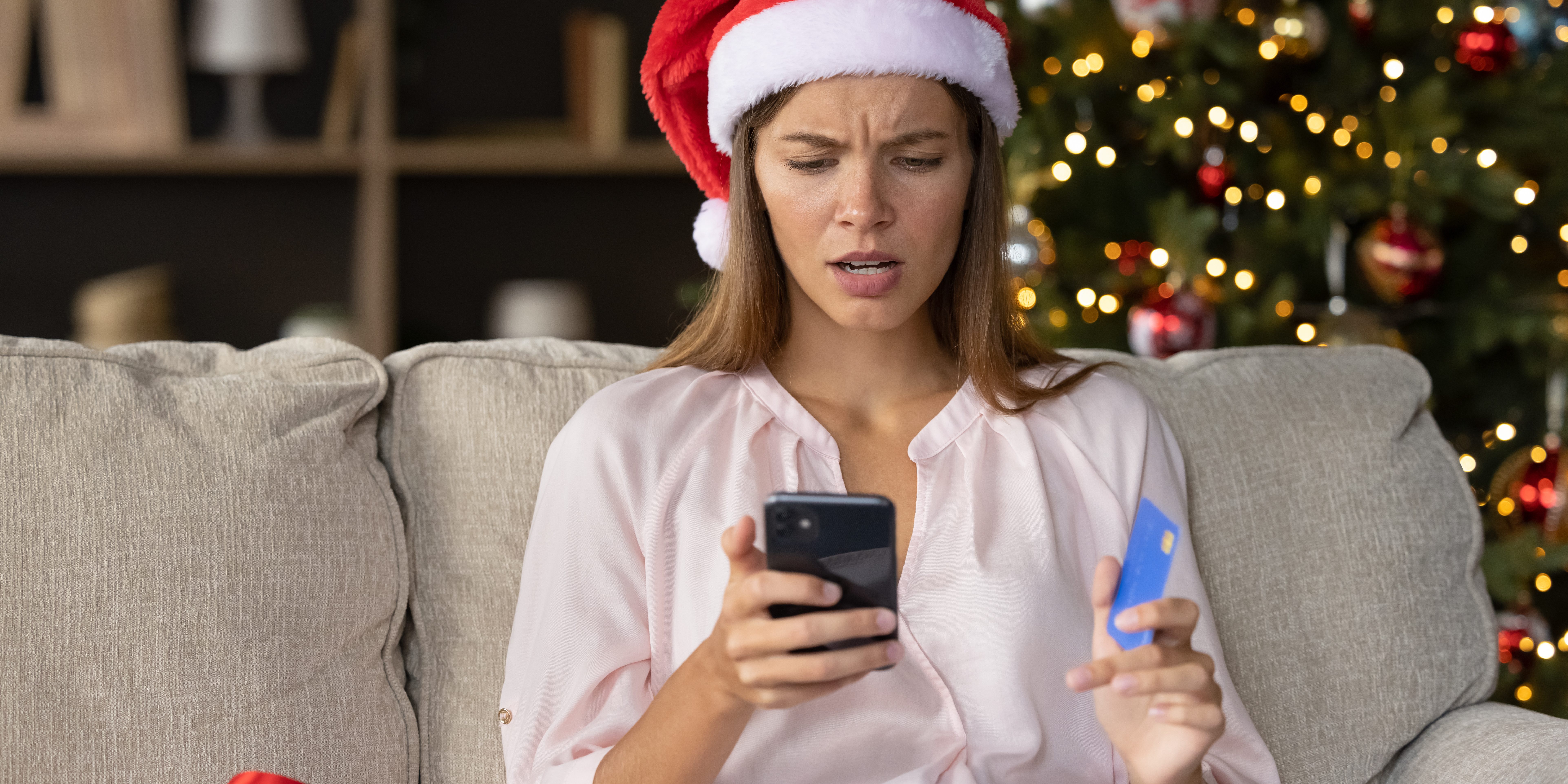 Worried concerned girl in Christmas Santa hat having problems